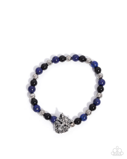 Beaded bracelet with blue and black beads and a silver clasp on a white background