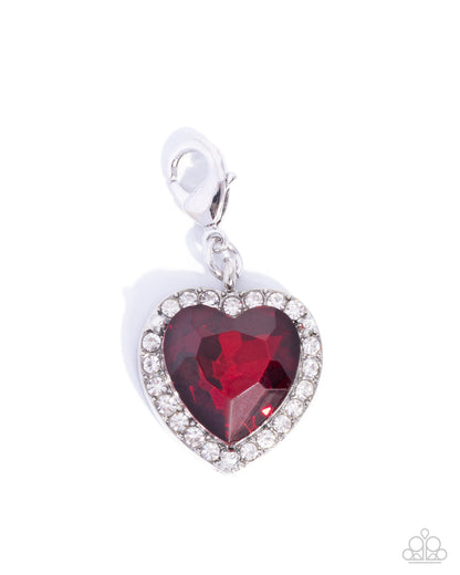 Heart-shaped red gemstone pendant with clear stones on a white background