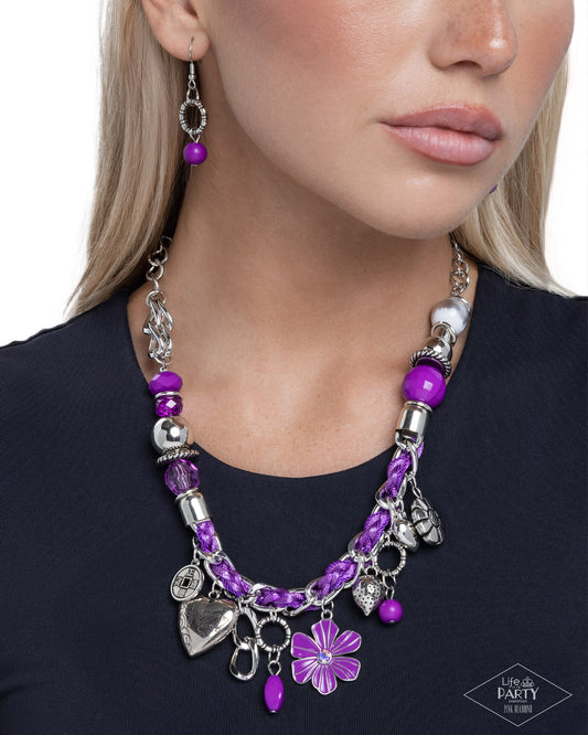 Purple beaded necklace with silver charms worn by a model on a white background