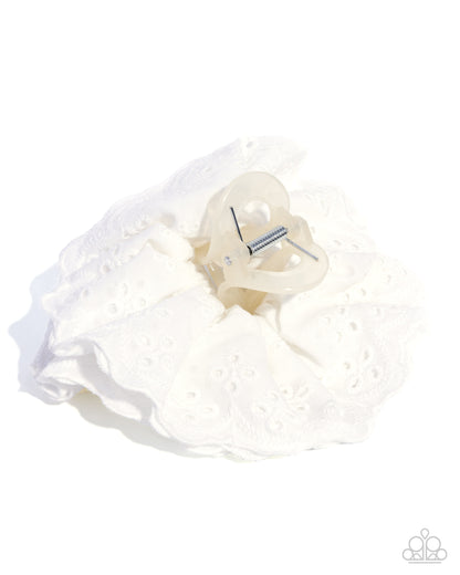 White garter with decorative bow on a white background