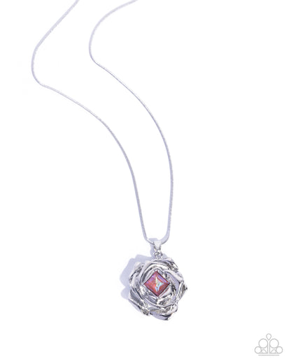 Necklace with a silver pendant featuring a pink gem on a white background