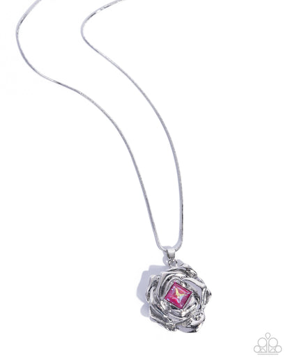 Silver necklace with a pink gemstone pendant on a white background