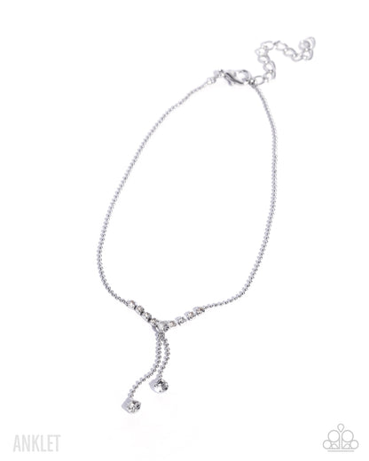 A silver-toned anklet with a delicate chain, a Y-shaped drop design, and a small heart charm, displayed on a clean white background.