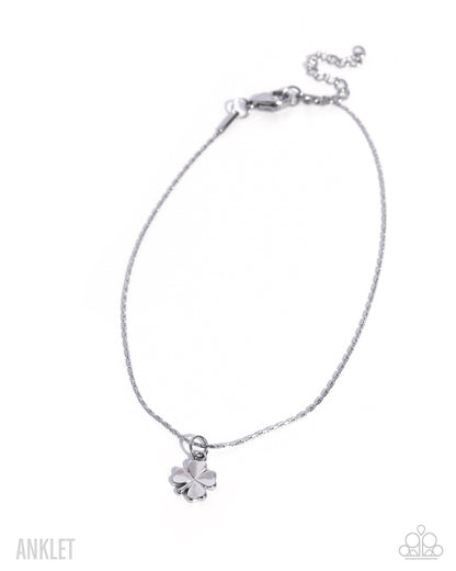 Silver anklet with a clover charm on a white background