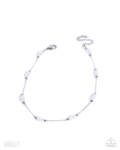 Silver anklet with white beads on a white background
