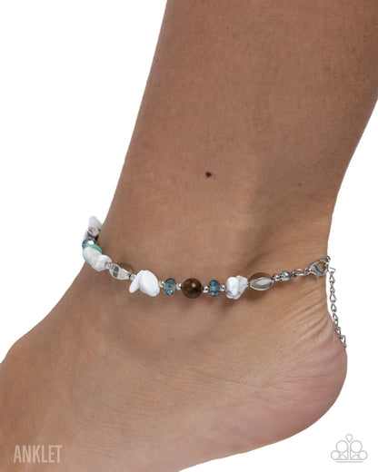 Ankle bracelet with multicolored beads on a white background