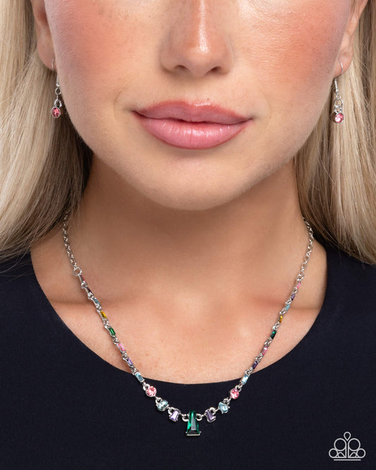 Close-up of a woman wearing a colorful beaded necklace and earrings.