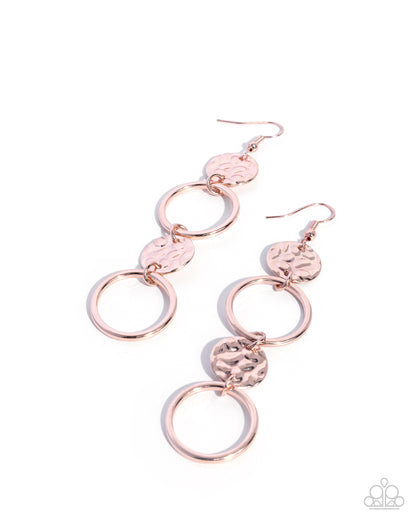 Rose gold circular earrings on a white background