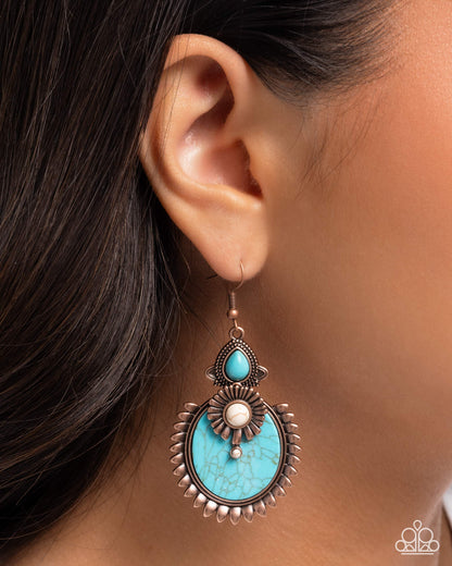 Turquoise earring worn by a person with dark hair.