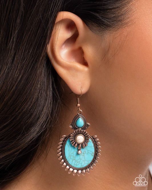 Turquoise earring worn by a person with dark hair.