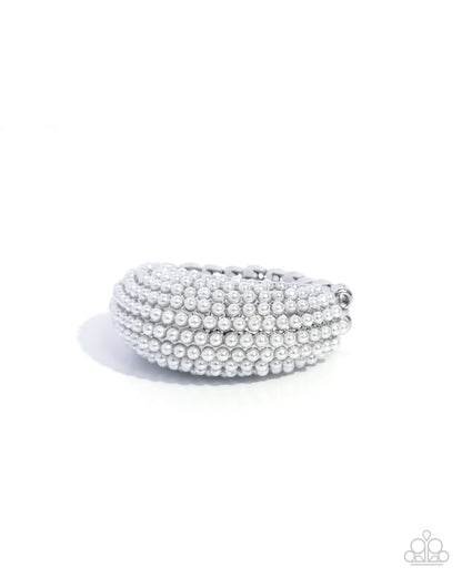 Stack of silver bangles on a white background