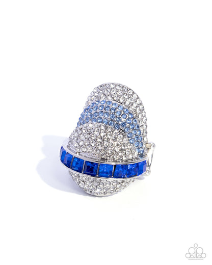 Decorative thimble with blue and silver gemstones on a white background