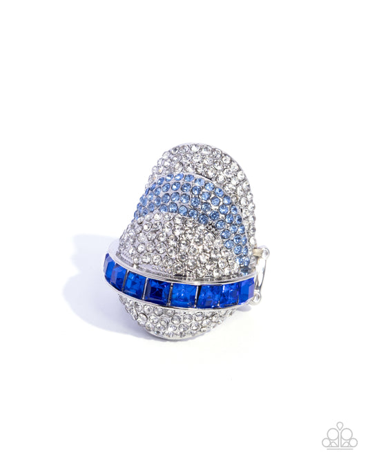 Decorative thimble with blue and silver gemstones on a white background