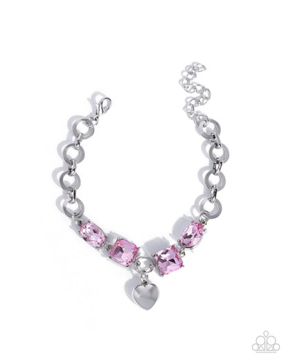 Silver bracelet with pink gemstones on a white background