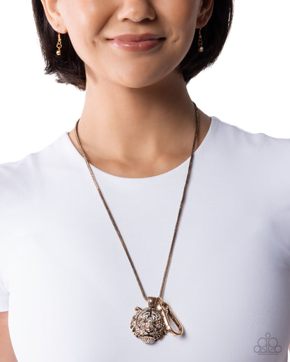 Person wearing a long necklace with a large pendant on a white background