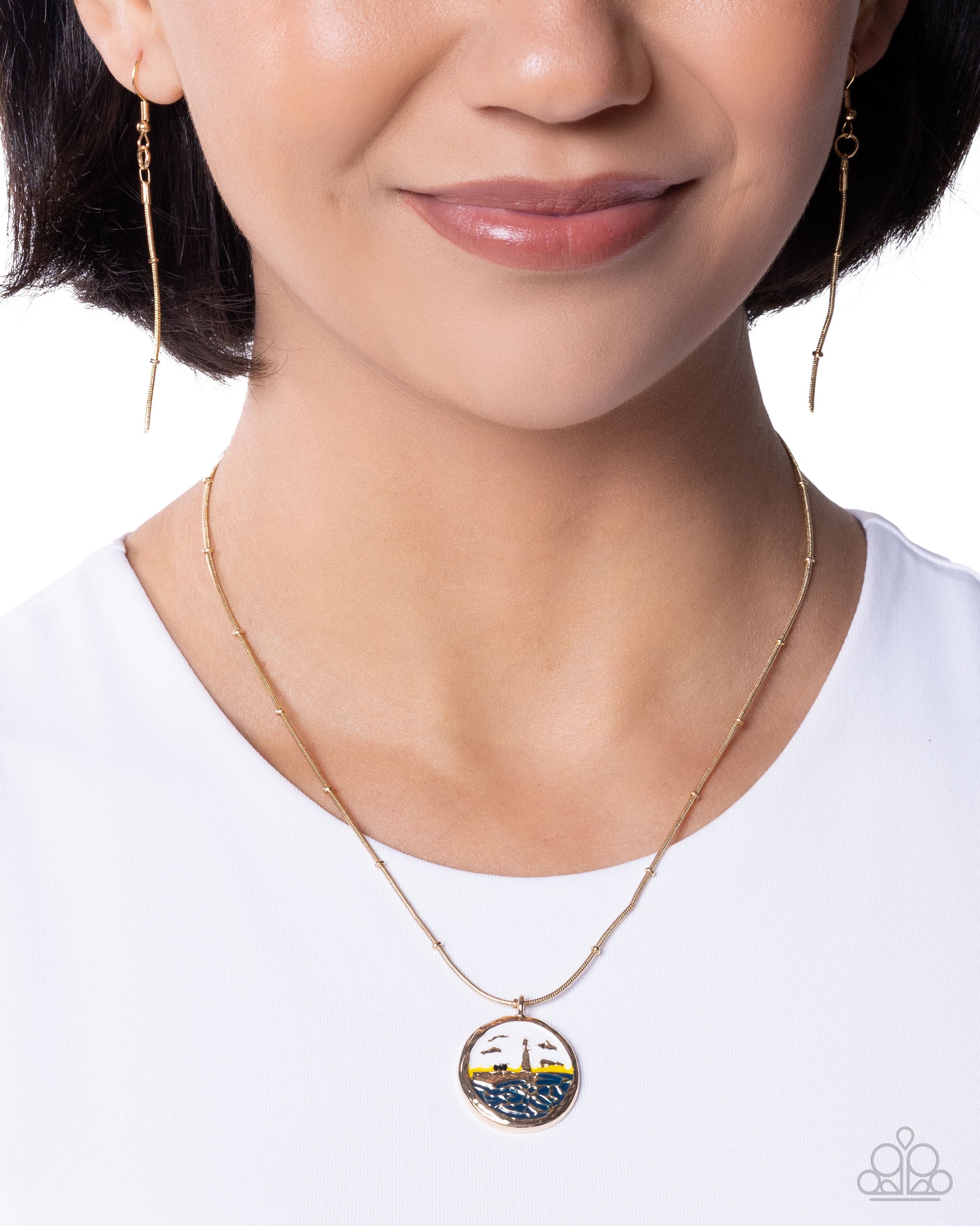 Close-up of a person wearing a gold necklace with a pendant on a white background