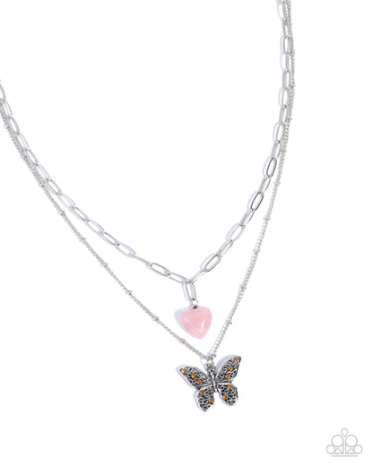 Necklace with butterfly and heart pendant on a white background