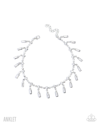 Silver anklet with dangling beads on a white background