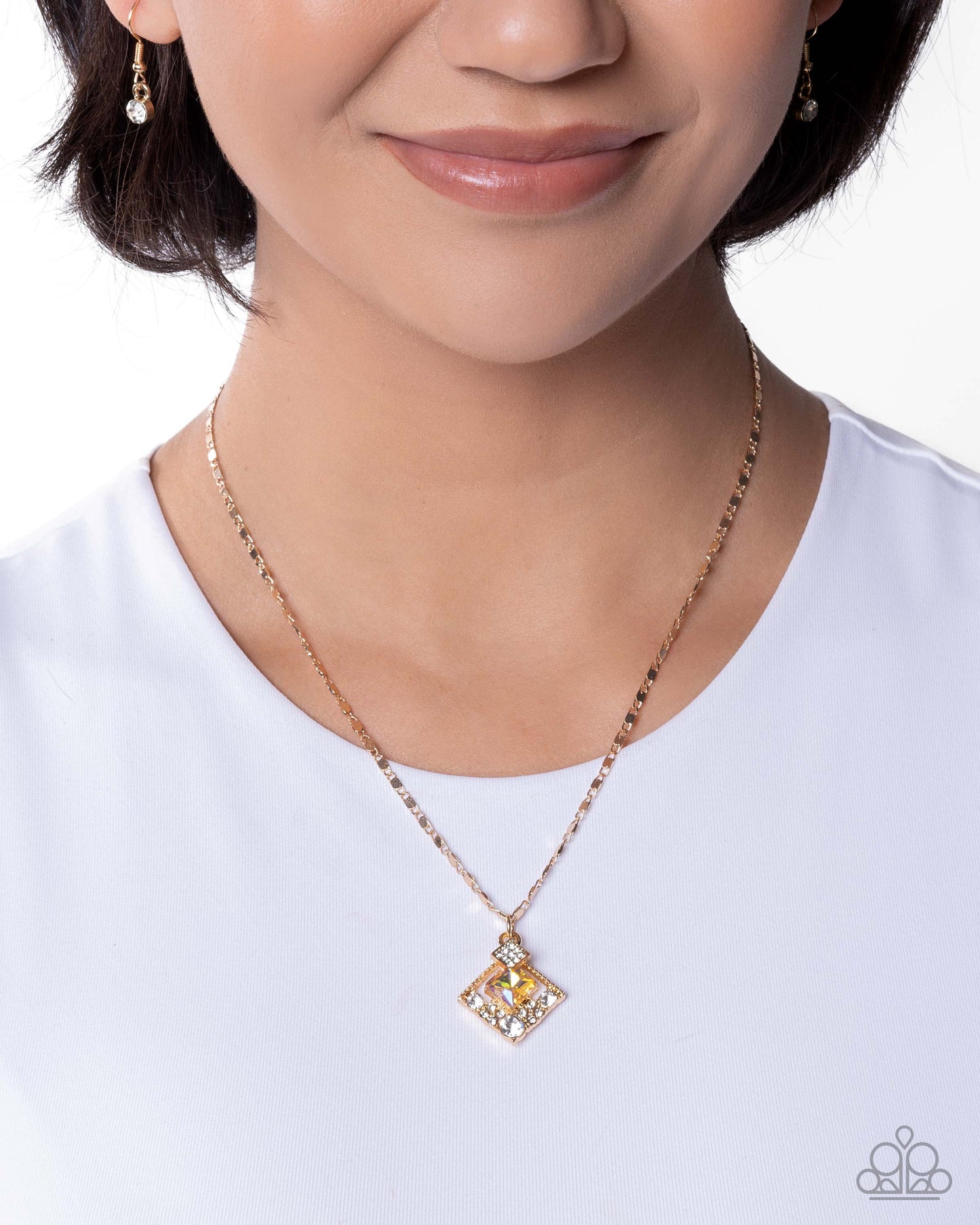 Person wearing a gold necklace with a square pendant on a white background