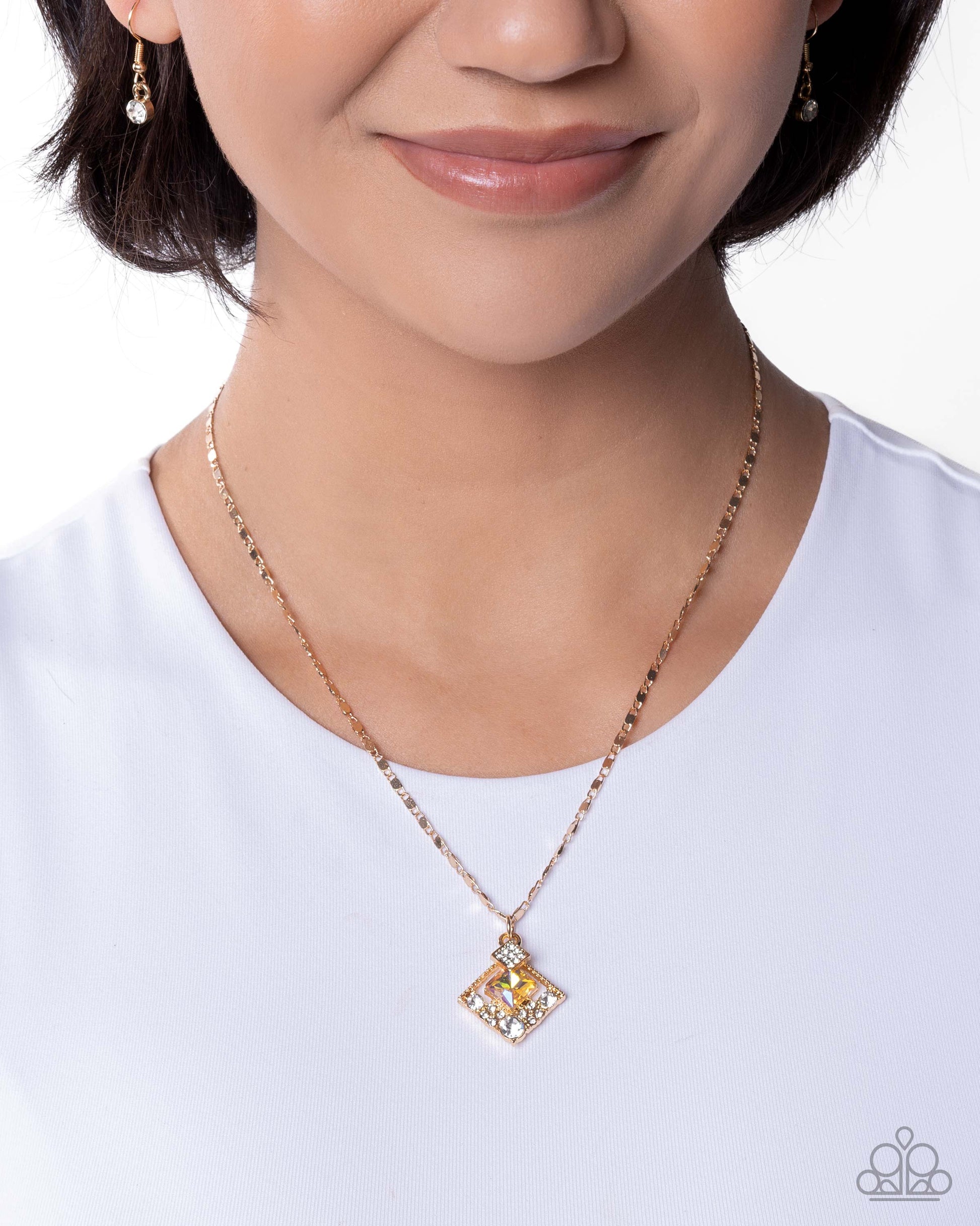 Person wearing a gold necklace with a square pendant on a white background