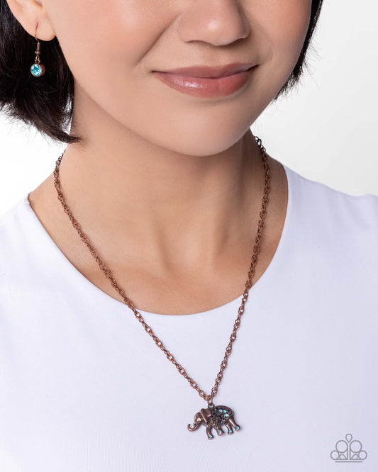 Necklace with elephant pendant worn by a model on a white background