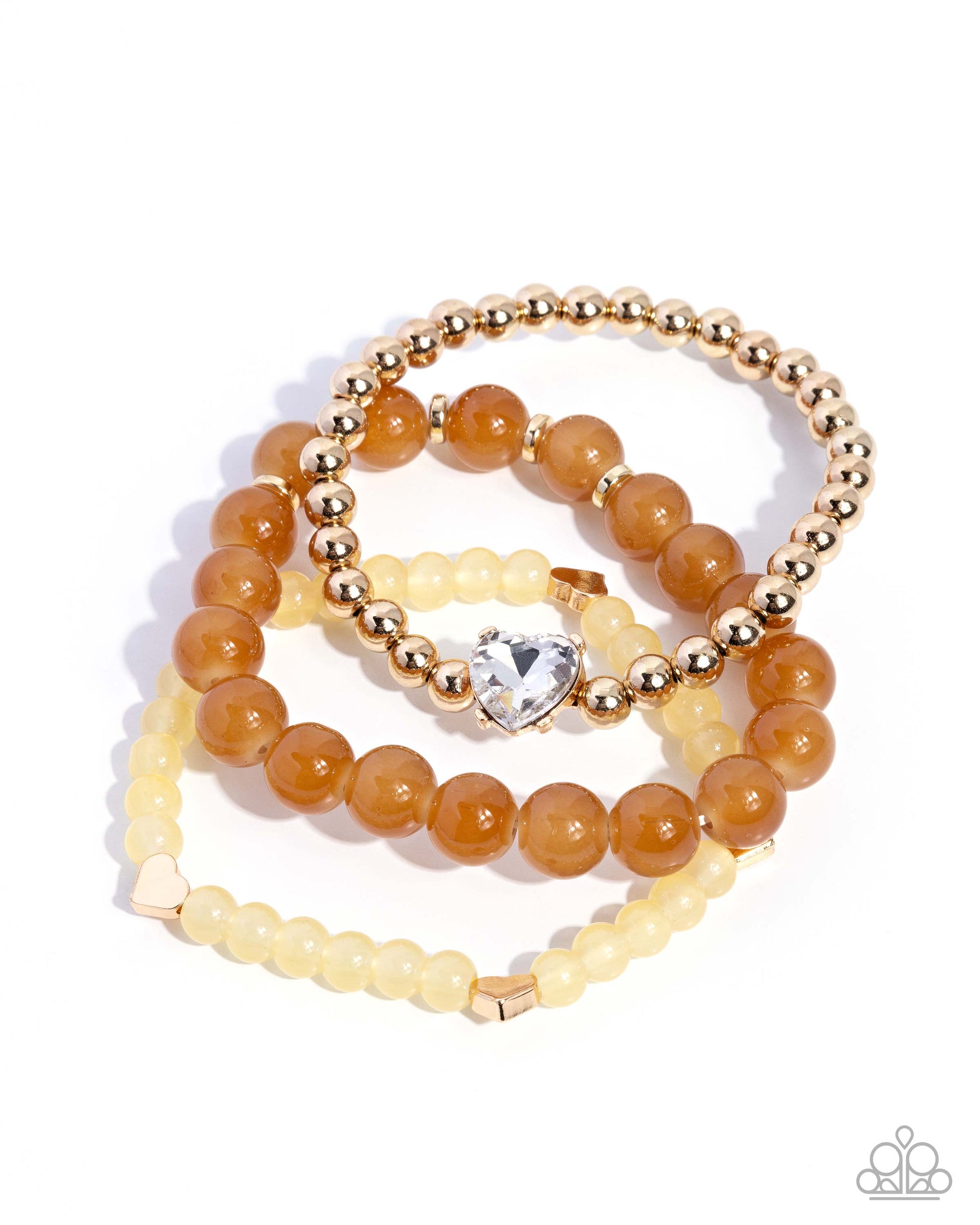 Set of beaded bracelets with gold and brown beads on a white background