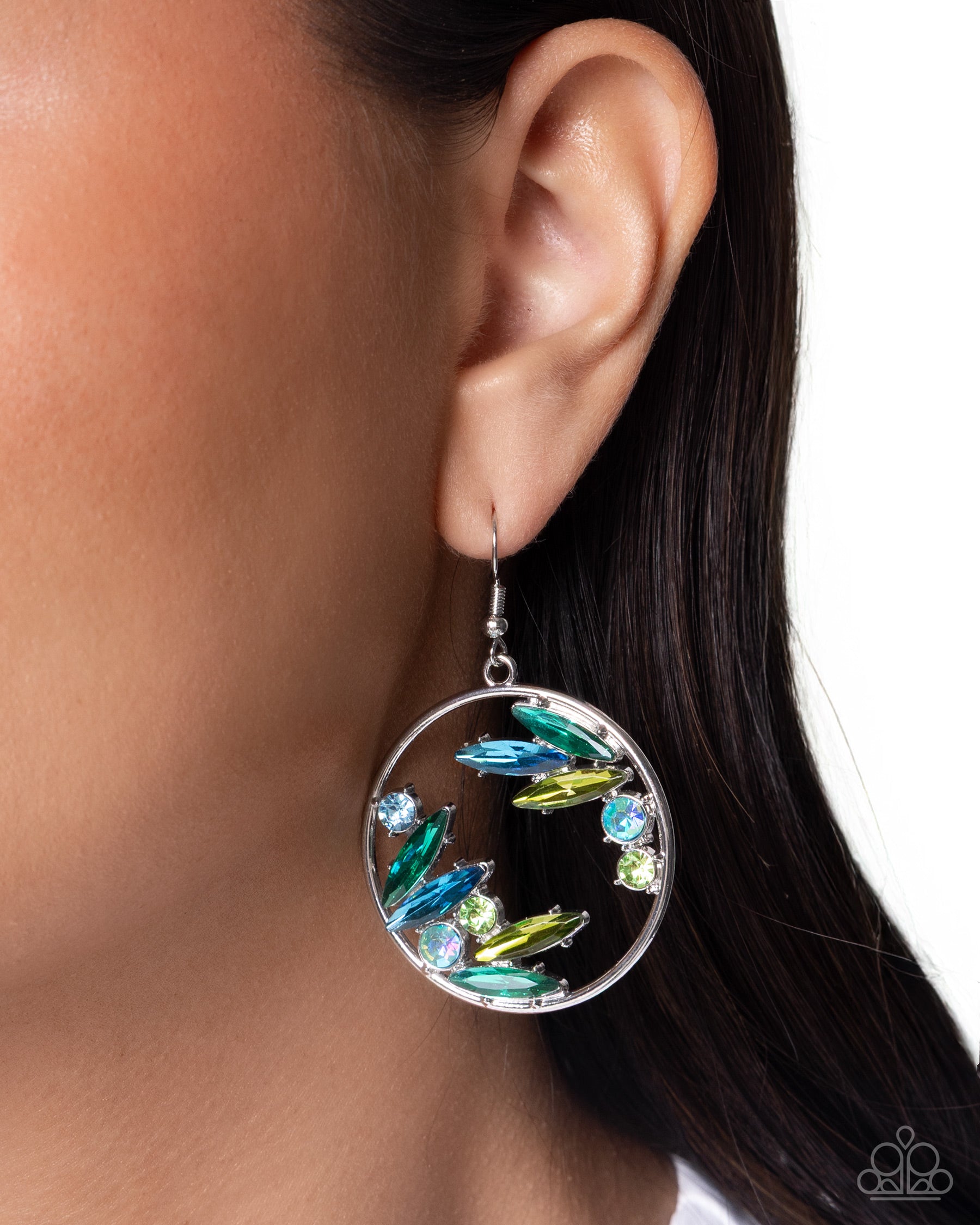 Close-up of an earring with colorful stones worn by a person