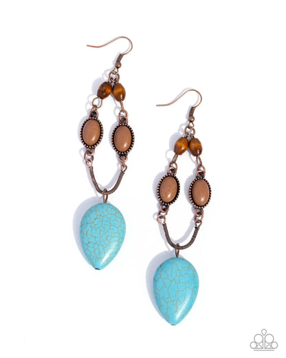 Pair of earrings with turquoise teardrop stones and brown beads on a white background