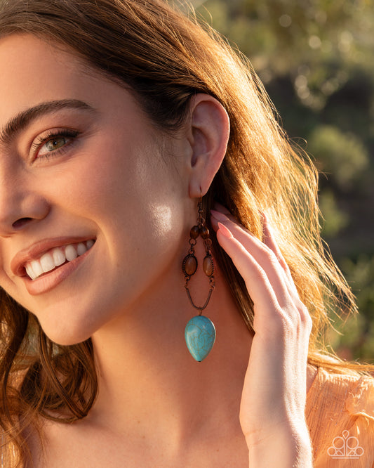 Close-up of a woman wearing turquoise earrings with a blurred natural background
