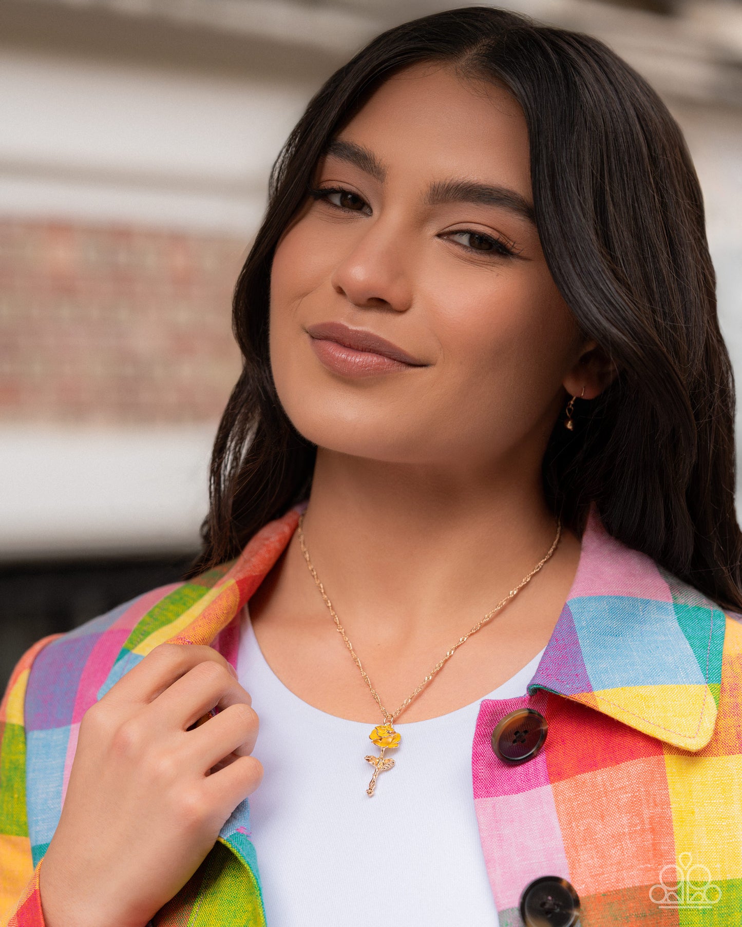 Woman wearing a colorful jacket with a blurred background