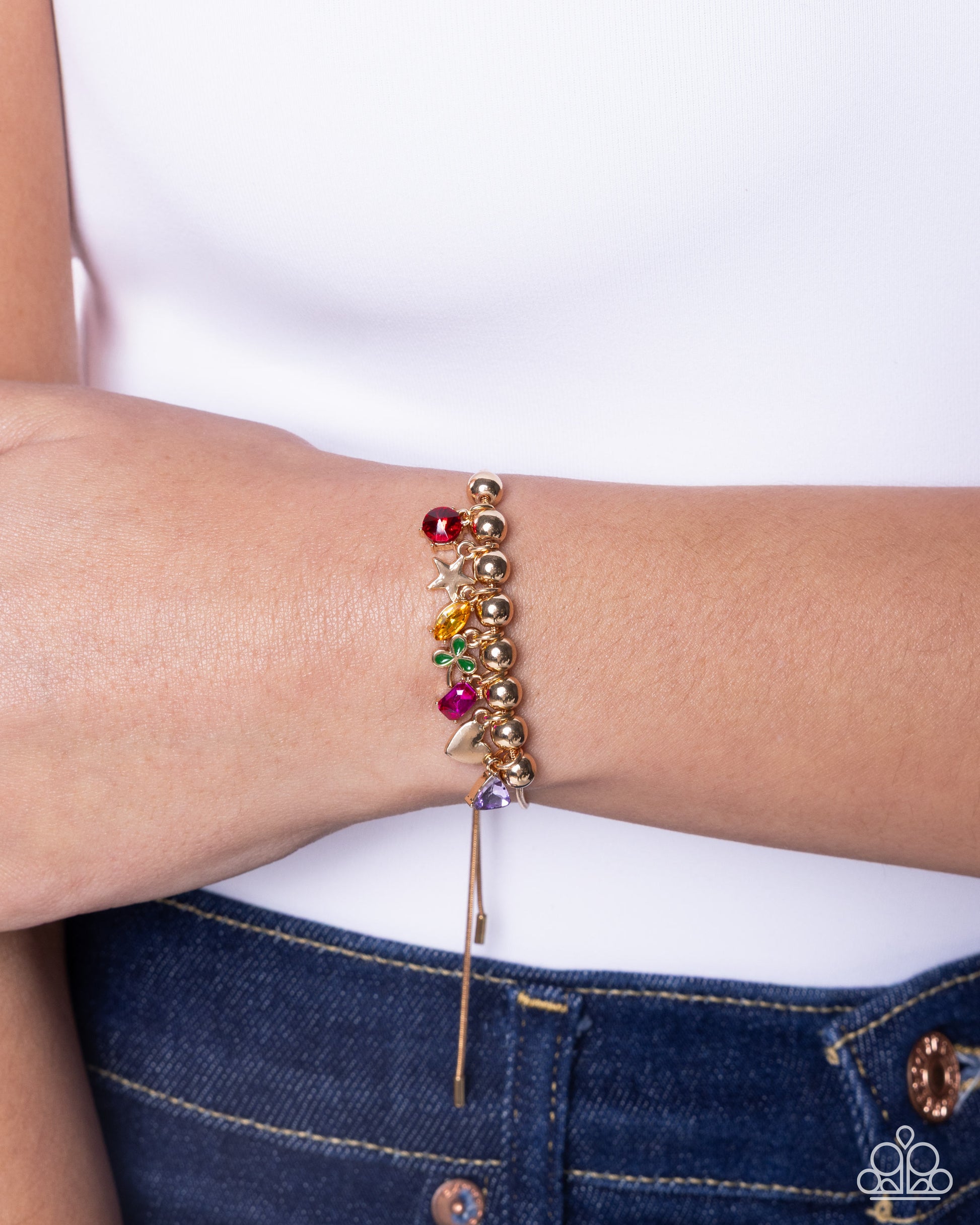 Multicolored beaded bracelet on a wrist with a white background
