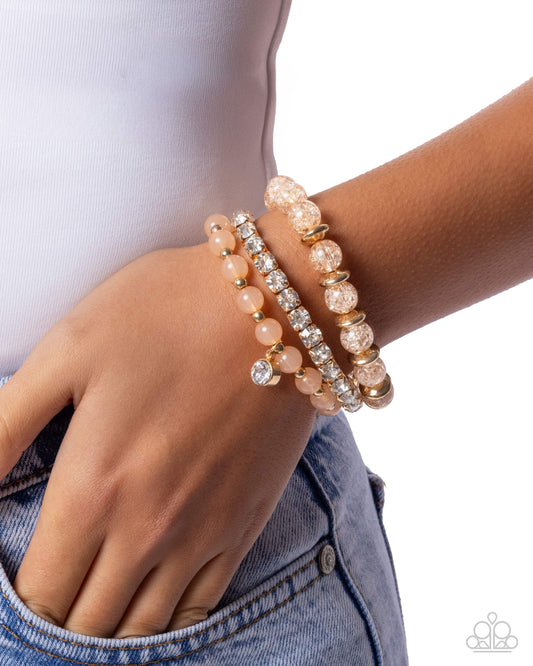 Close-up of a wrist wearing multiple beaded bracelets on a white background