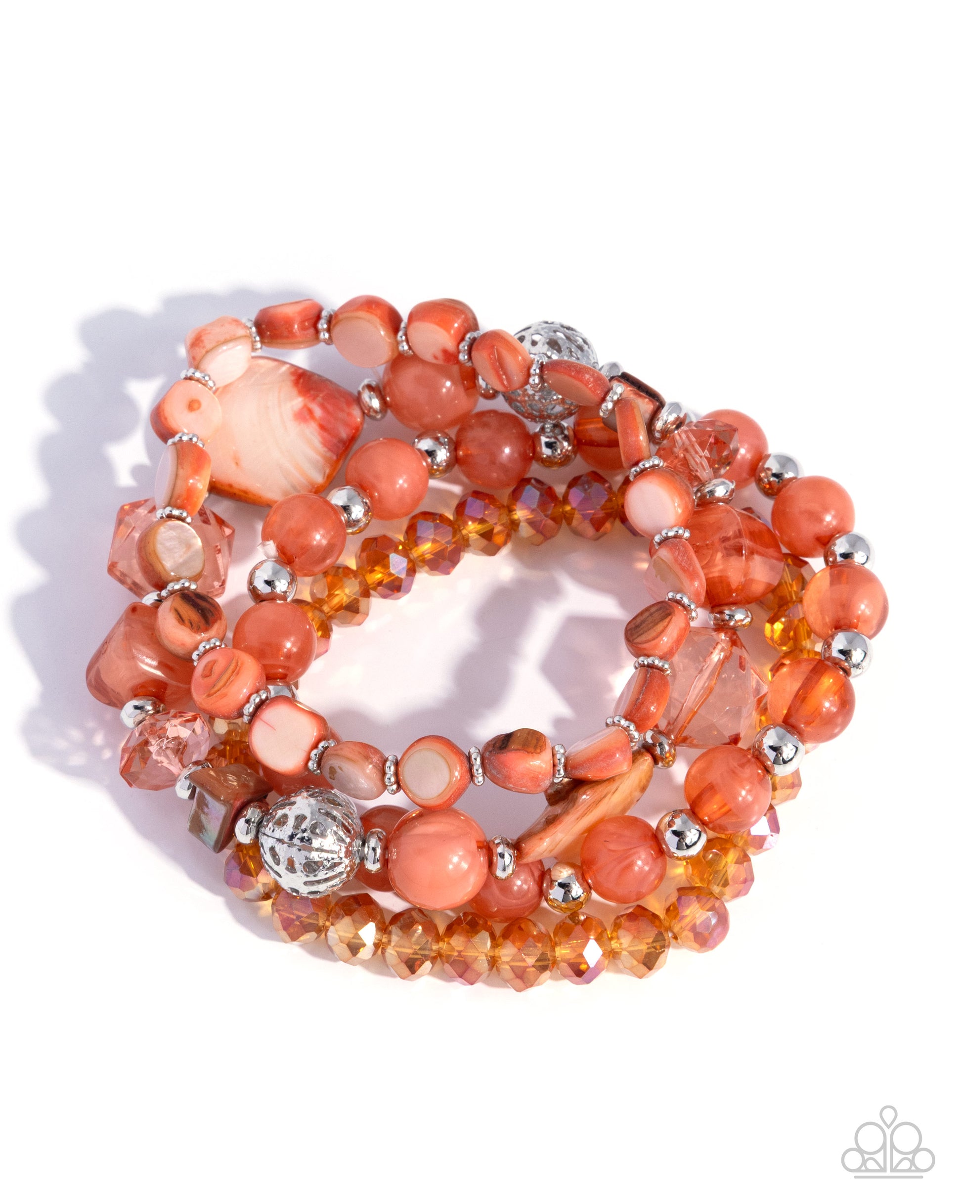 Stack of orange and silver beaded bracelets on a white background
