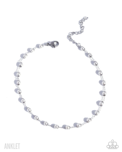 Silver beaded anklet on a white background