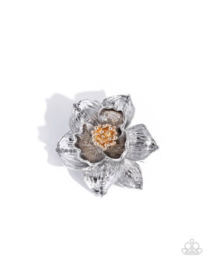 A silver-toned flower-shaped brooch with a textured, ribbed petal design and a central cluster of small gold and clear stones, shown on a white background with a soft shadow.