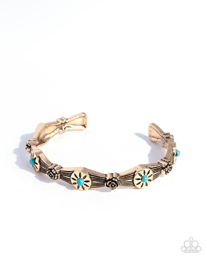Gold bracelet with turquoise stones on a white background