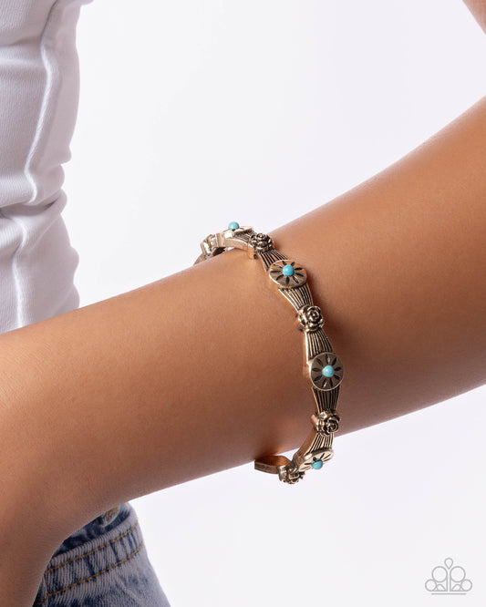 Bracelet with turquoise stones on a wrist against a white background