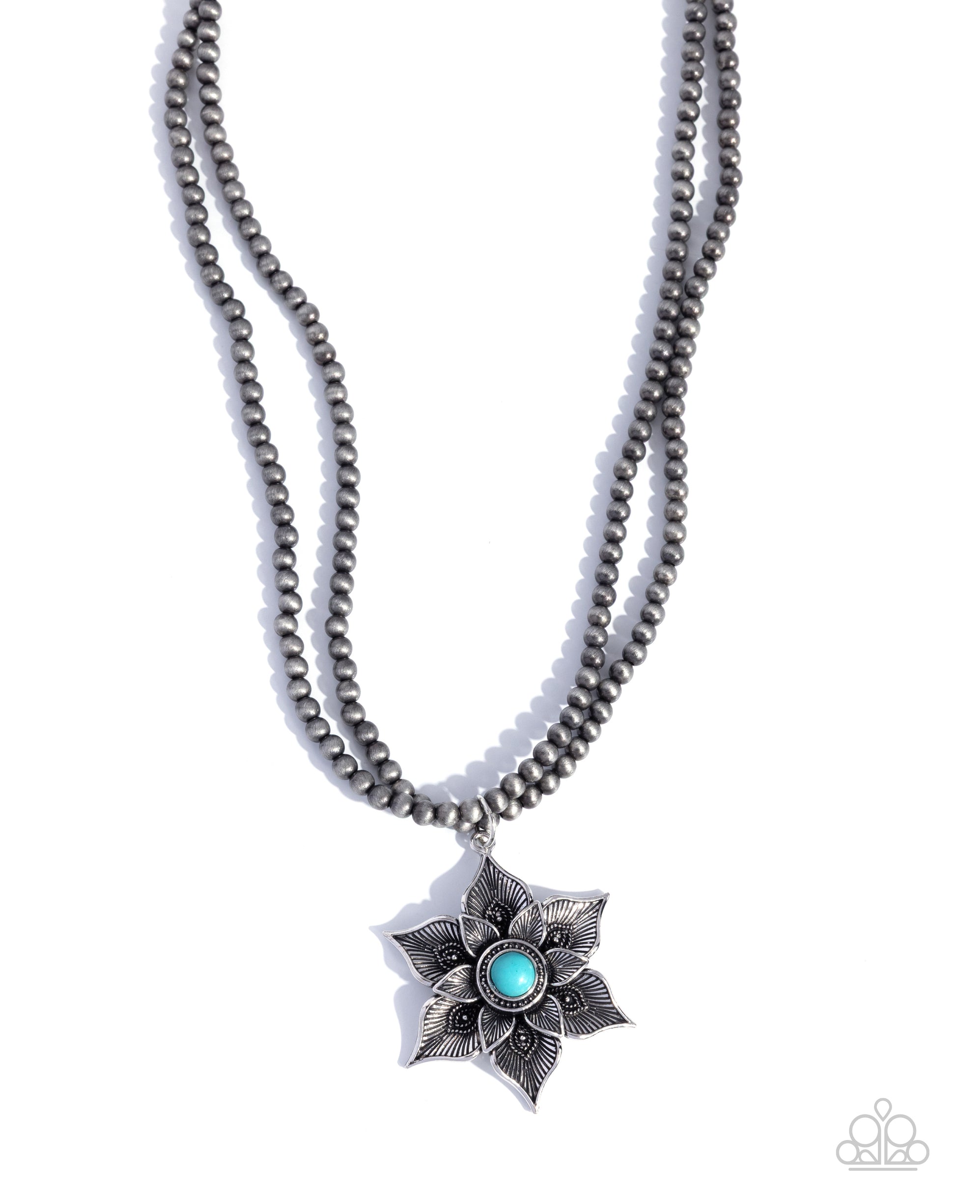 Necklace with star-shaped pendant featuring a blue gemstone on a white background