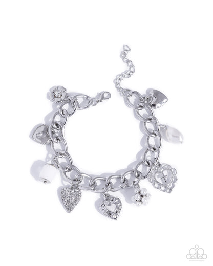 Silver charm bracelet on a white background