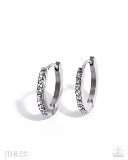 Pair of silver hoop earrings with clear gemstones on a white background