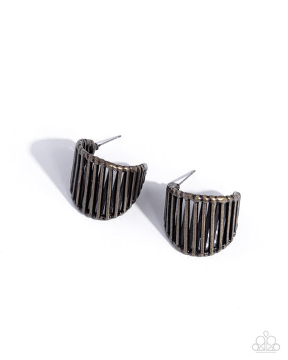 Pair of black ribbed earrings on a white background