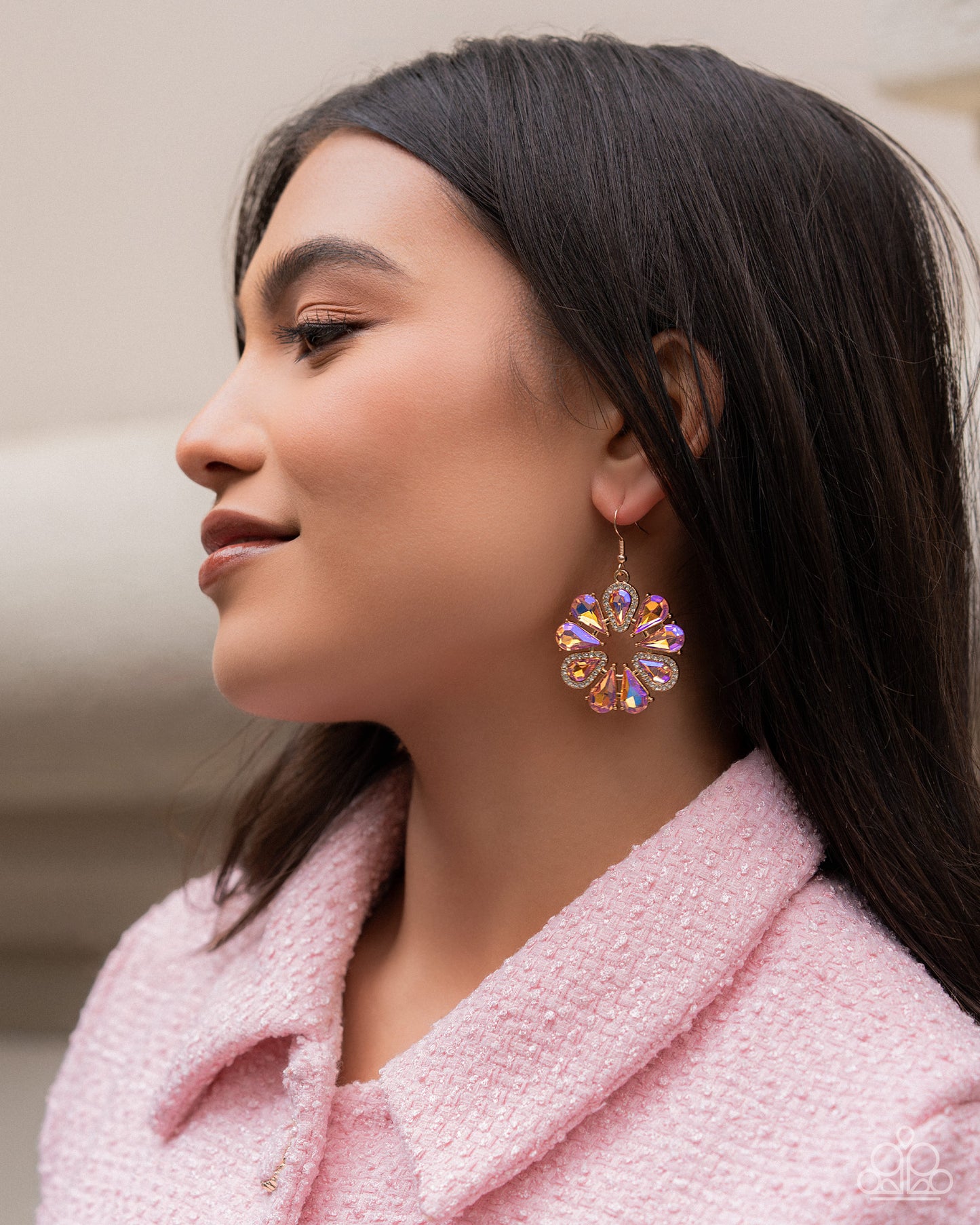 Woman wearing a colorful earring with a blurred background
