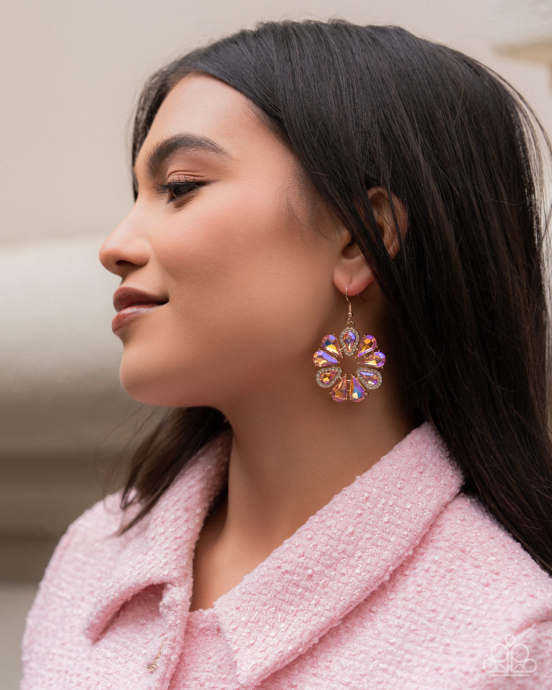 Woman wearing a colorful earring with a blurred background