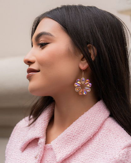 Woman wearing a colorful earring with a blurred background