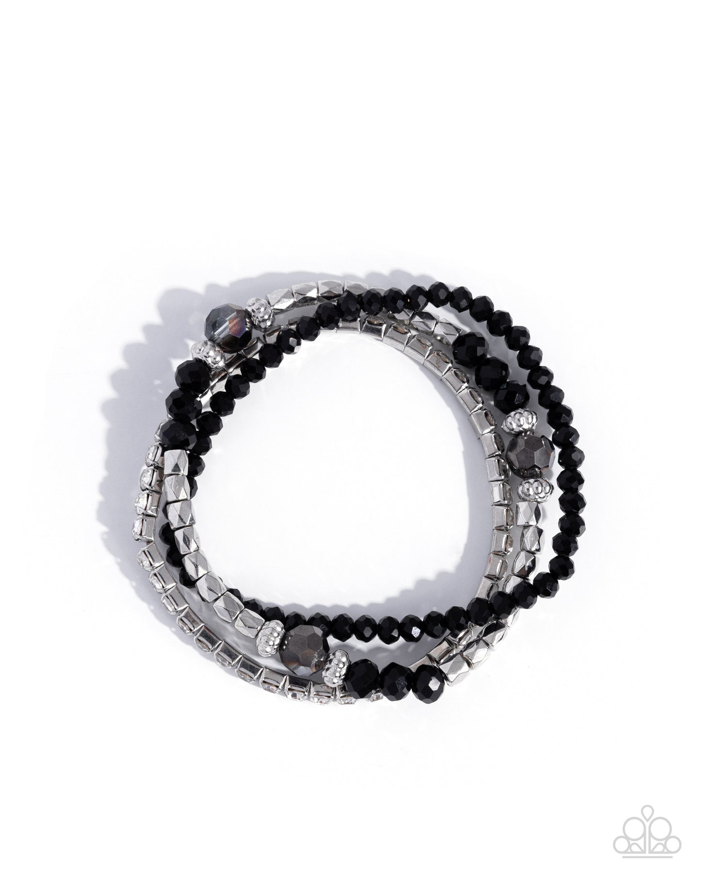 Stack of black beaded bracelets with silver accents on a white background