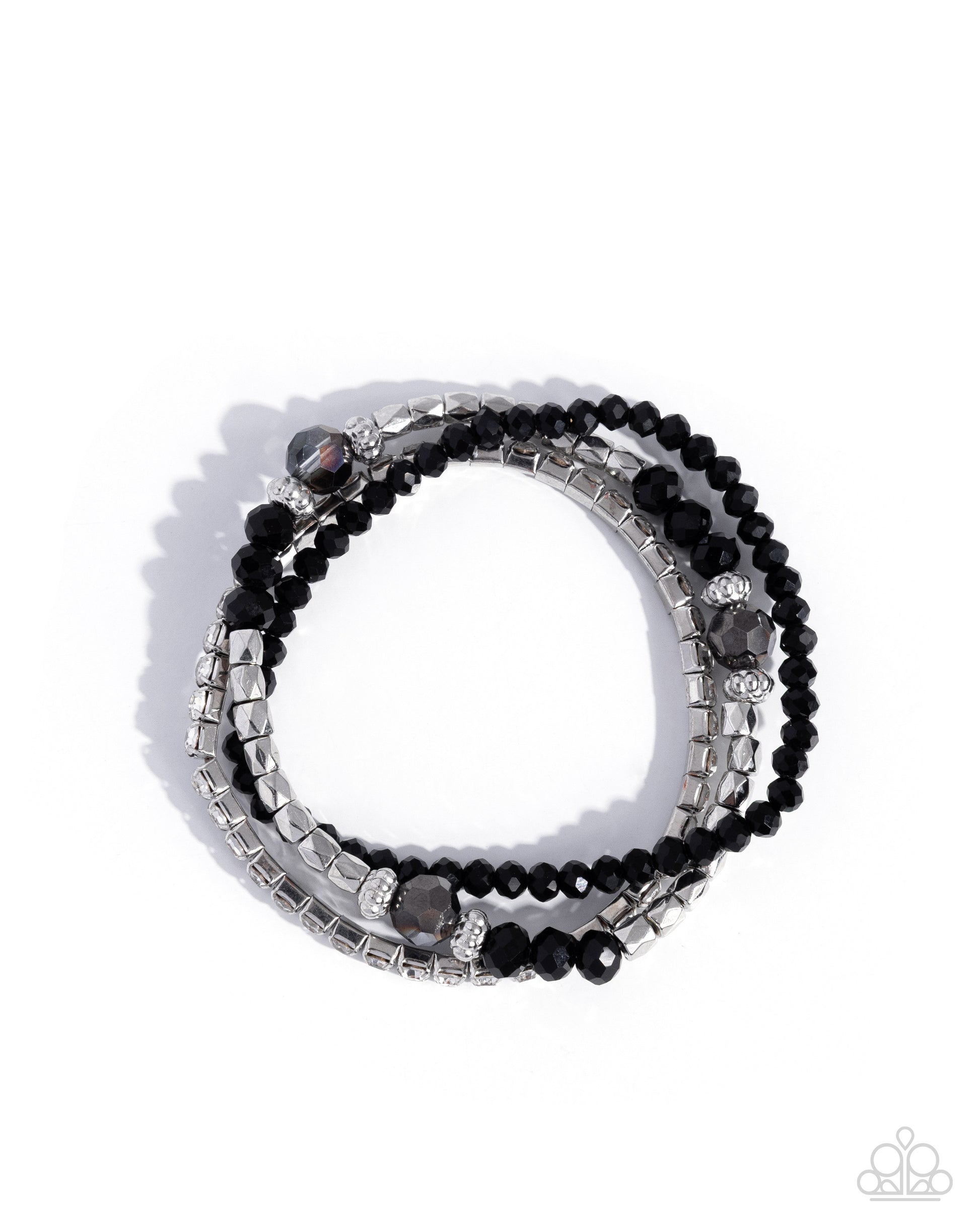 Stack of black beaded bracelets with silver accents on a white background