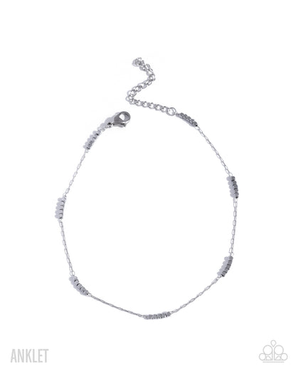 Silver anklet with small beads on a white background