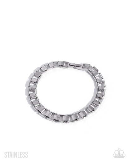 Silver ring with a textured band on a white background