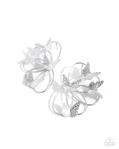 Silver butterfly earrings on a white background