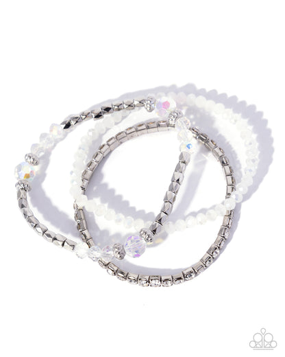 Set of beaded bracelets with silver accents on a white background